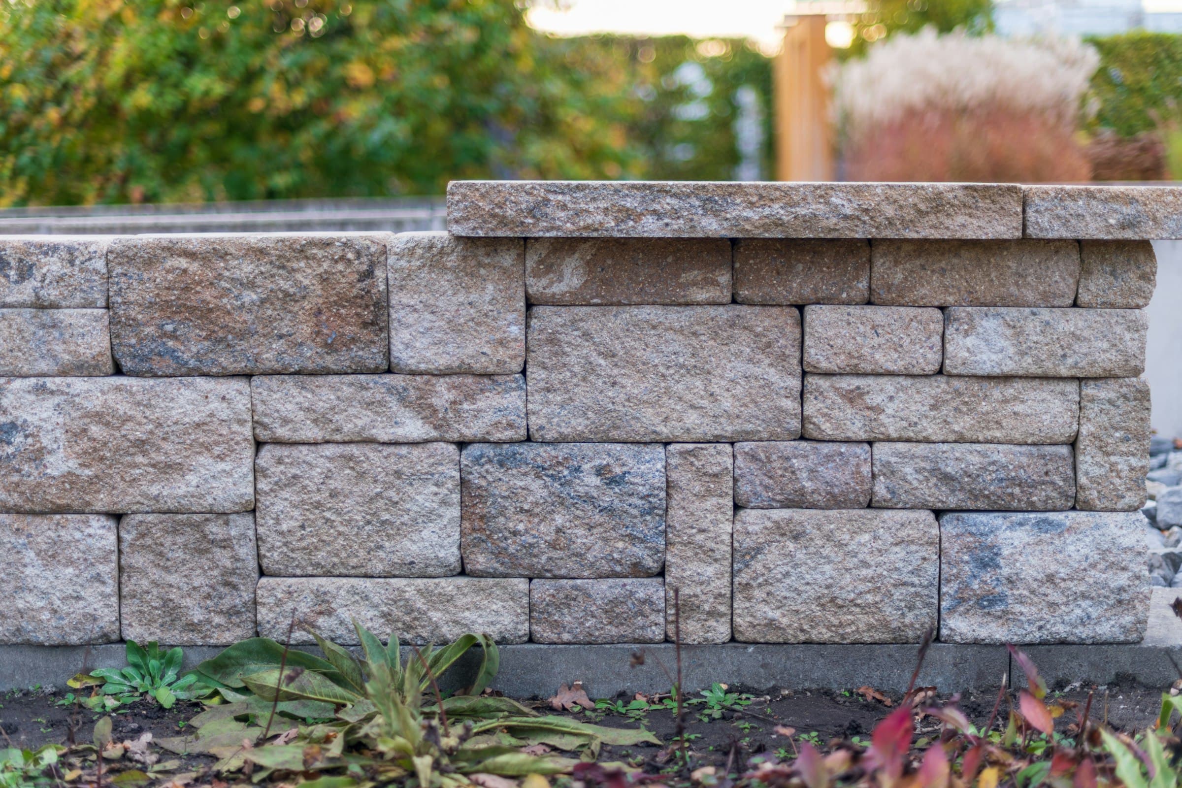 Manicured front yard with interlocking stone walkway and fresh garden beds